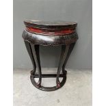 A wooden black and red lacquered console table. China, 20th century.