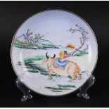 An enamel plate decorated with a water buffalo and a figure in a landscape. China, 18/19th century.