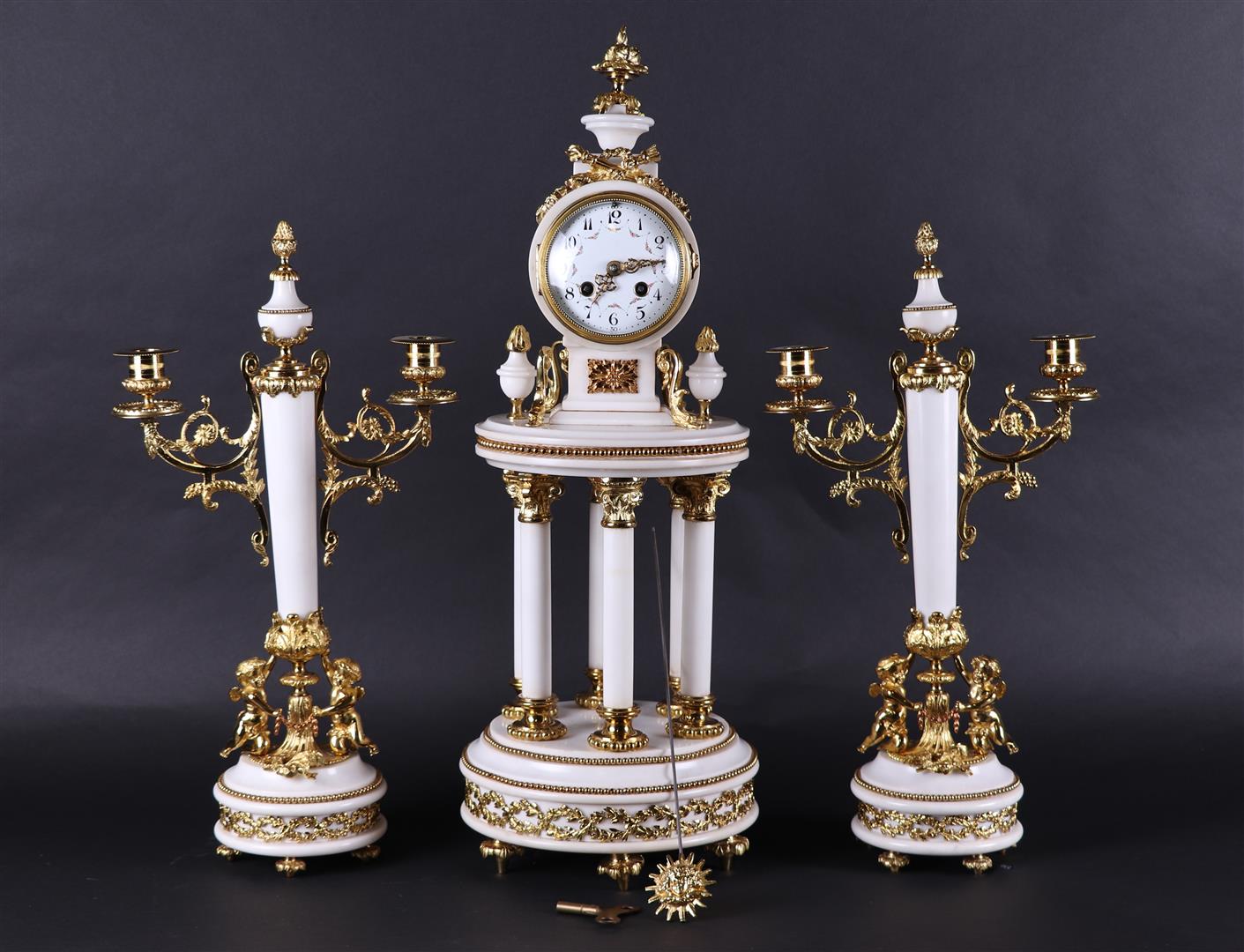 A white marble fireplace set with "gilded" brass frames. France, 20th century.