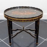 A Chinoiserie oval table with cross base.