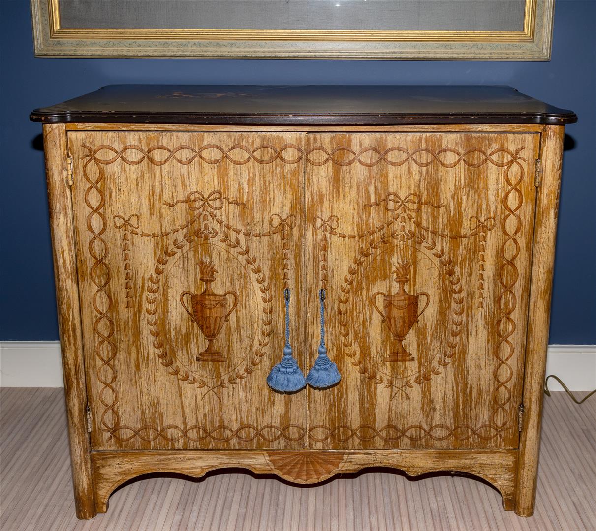 A decorative sideboard with blackened wooden top.