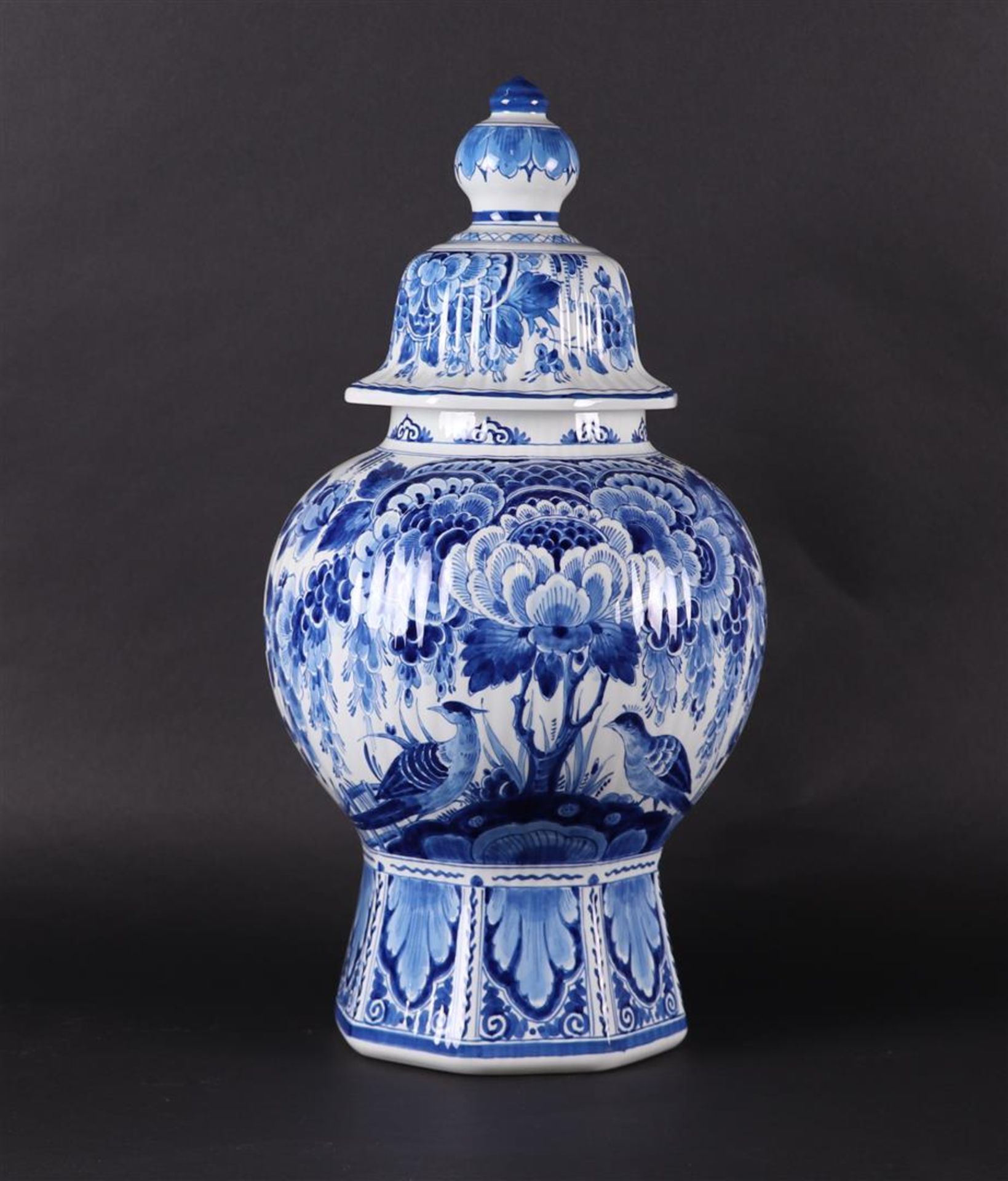 A very large earthenware vase decorated with a peacock in a landscape. "De Porseleyne Fles"