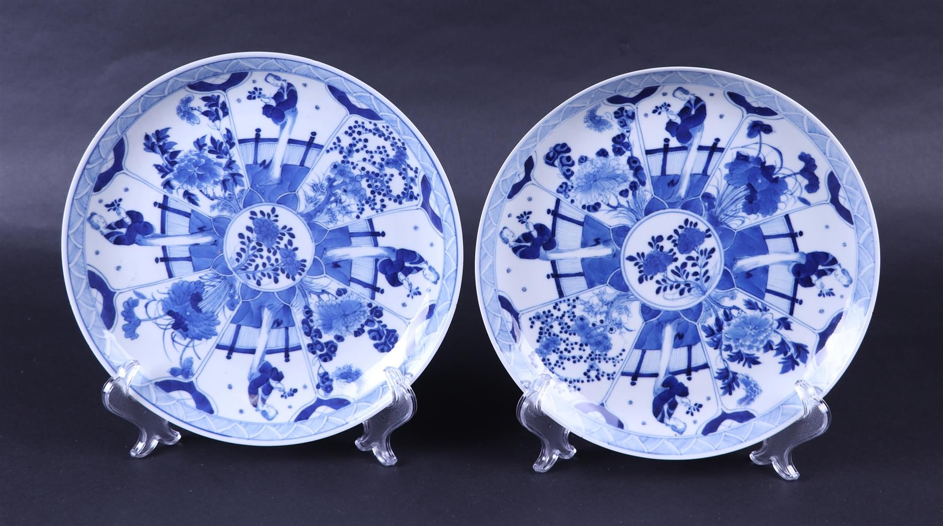 A set of two porcelain dishes decorated with flowers in flower beds, marked Kangxi. China, 