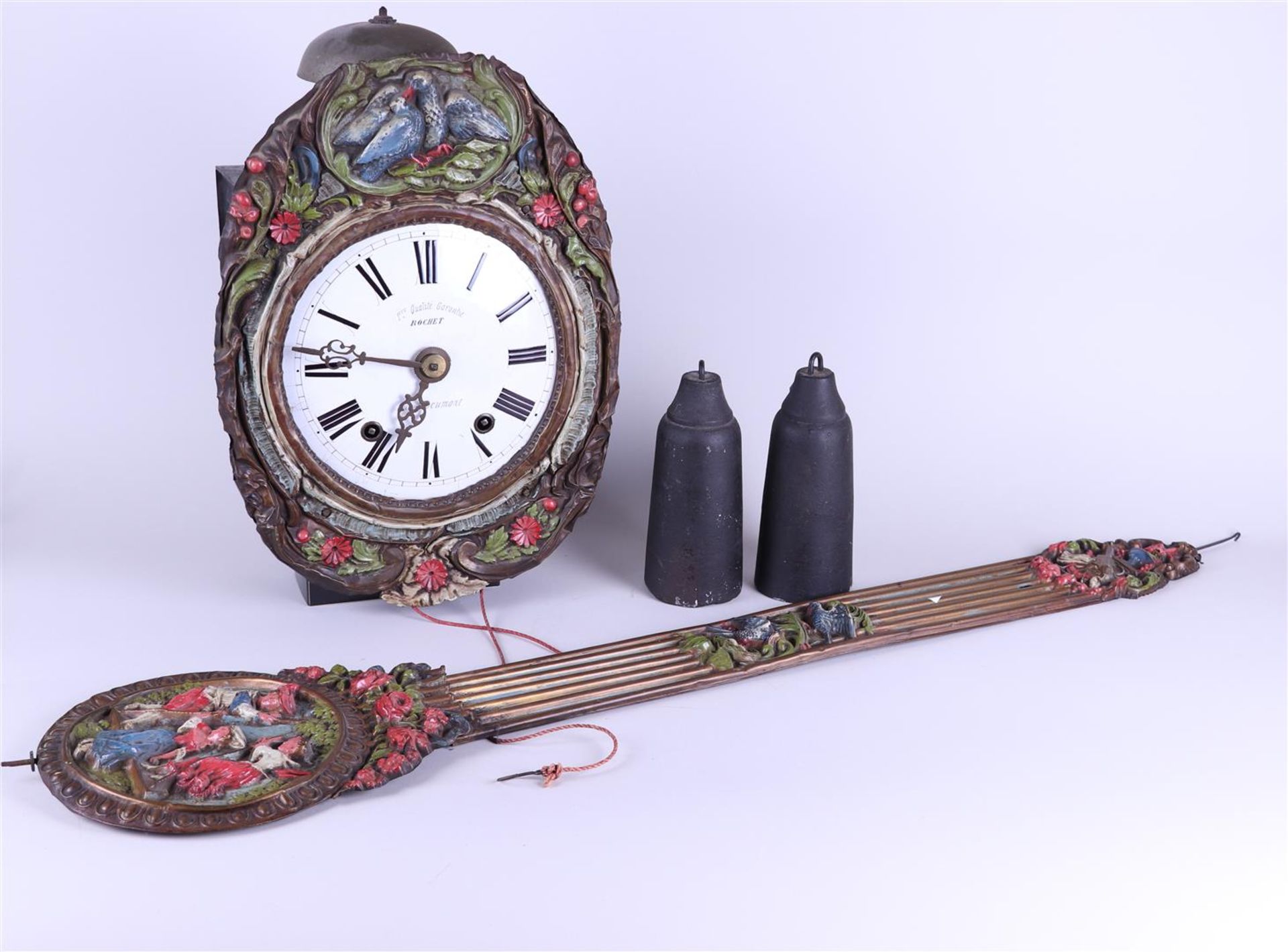 A French comptoise clock with polychrome laton copper rim in which a dove and ditto pendulum depicti