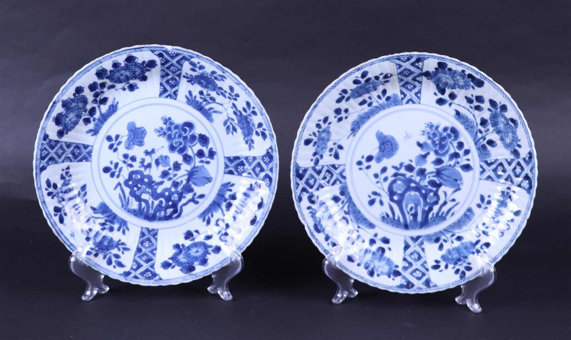 A set of two ribbed dishes with a floral design in  compartments and with a garden design in the cen