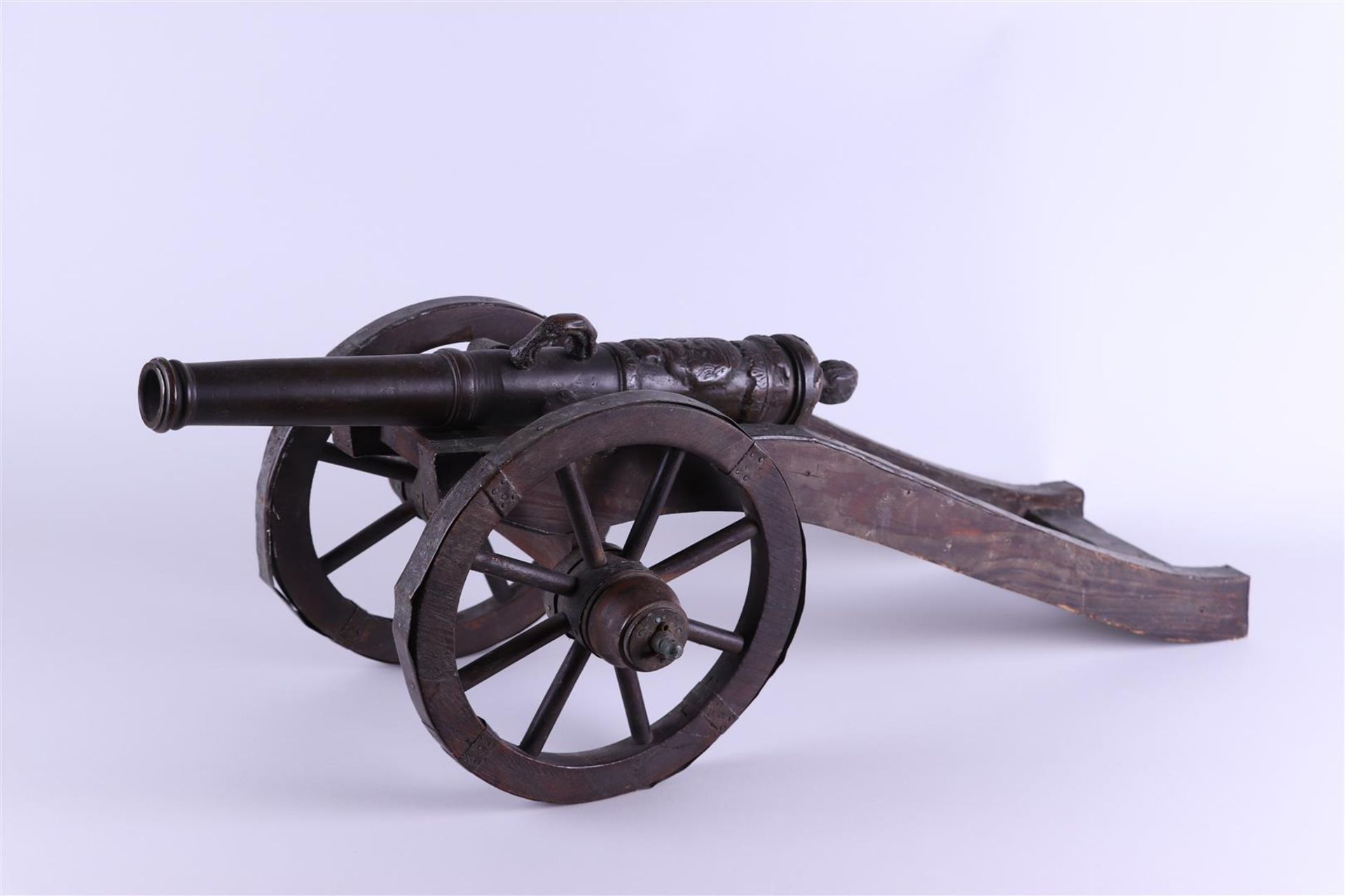 A bronze field gun on a wooden carriage. Tabletop model. The barrel dated 1630. ca. 1890.  