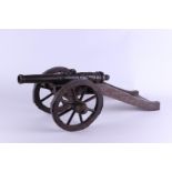 A bronze field gun on a wooden carriage. Tabletop model. The barrel dated 1630. ca. 1890.