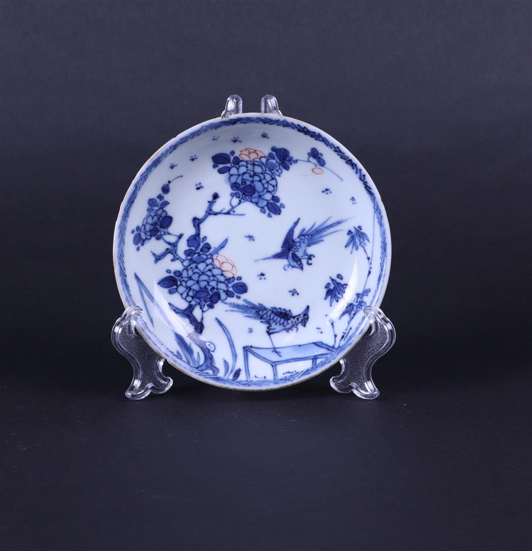 A porcelain partly polychrome plate with a decoration of pheasants. China, Early Kangxi,