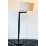 An adjustable wrought iron floor lamp with white shade. Dimmable.