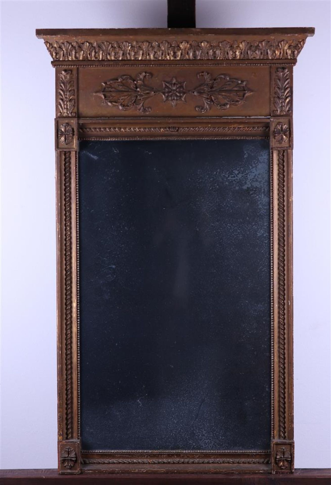 An Empire mirror made of carved lime wood. Approx. 1820. Fitted with the original glass.