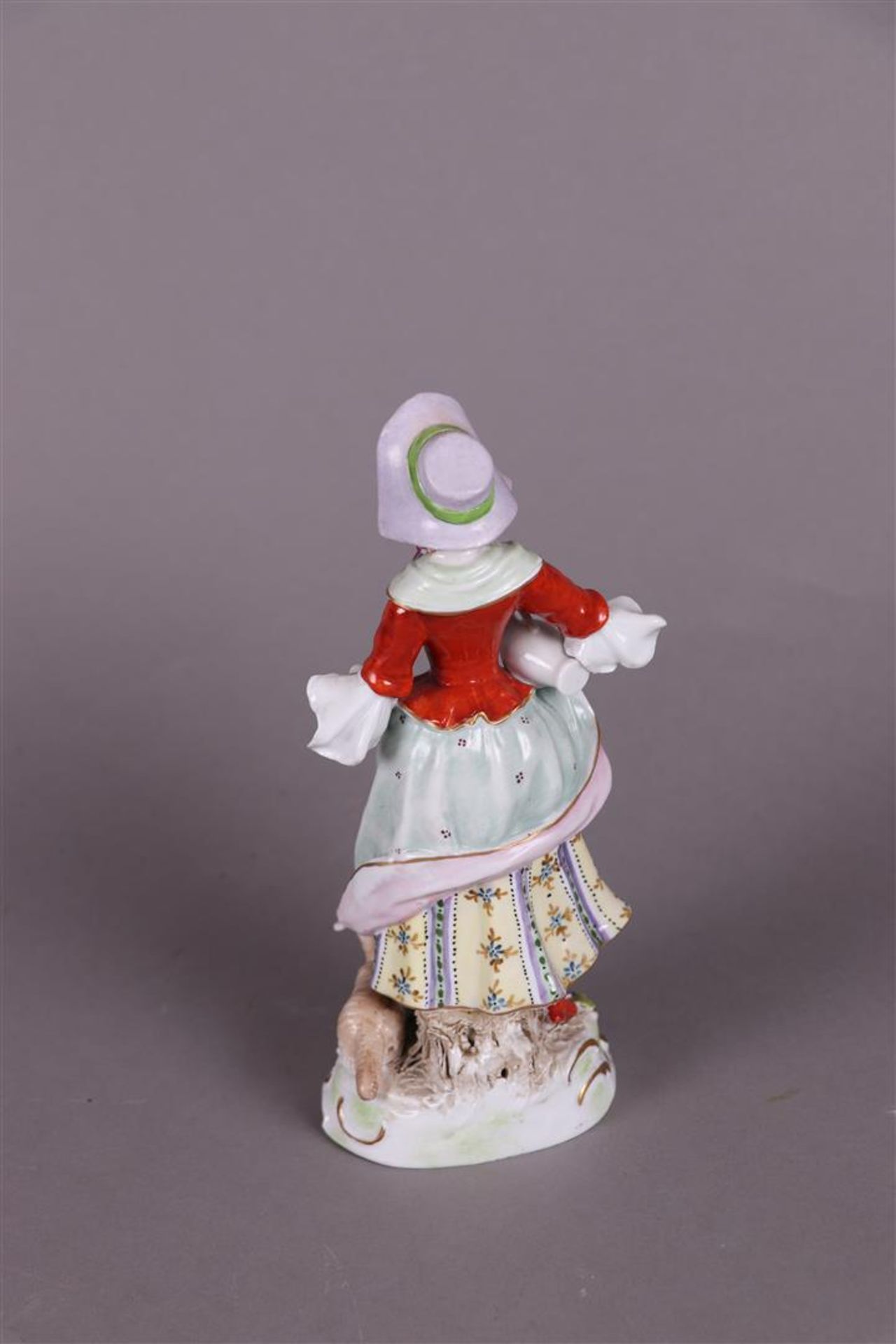 A porcelain figure of a girl holding  a jug and flowers, marked Sitzendorf Thüringen.  - Image 2 of 3