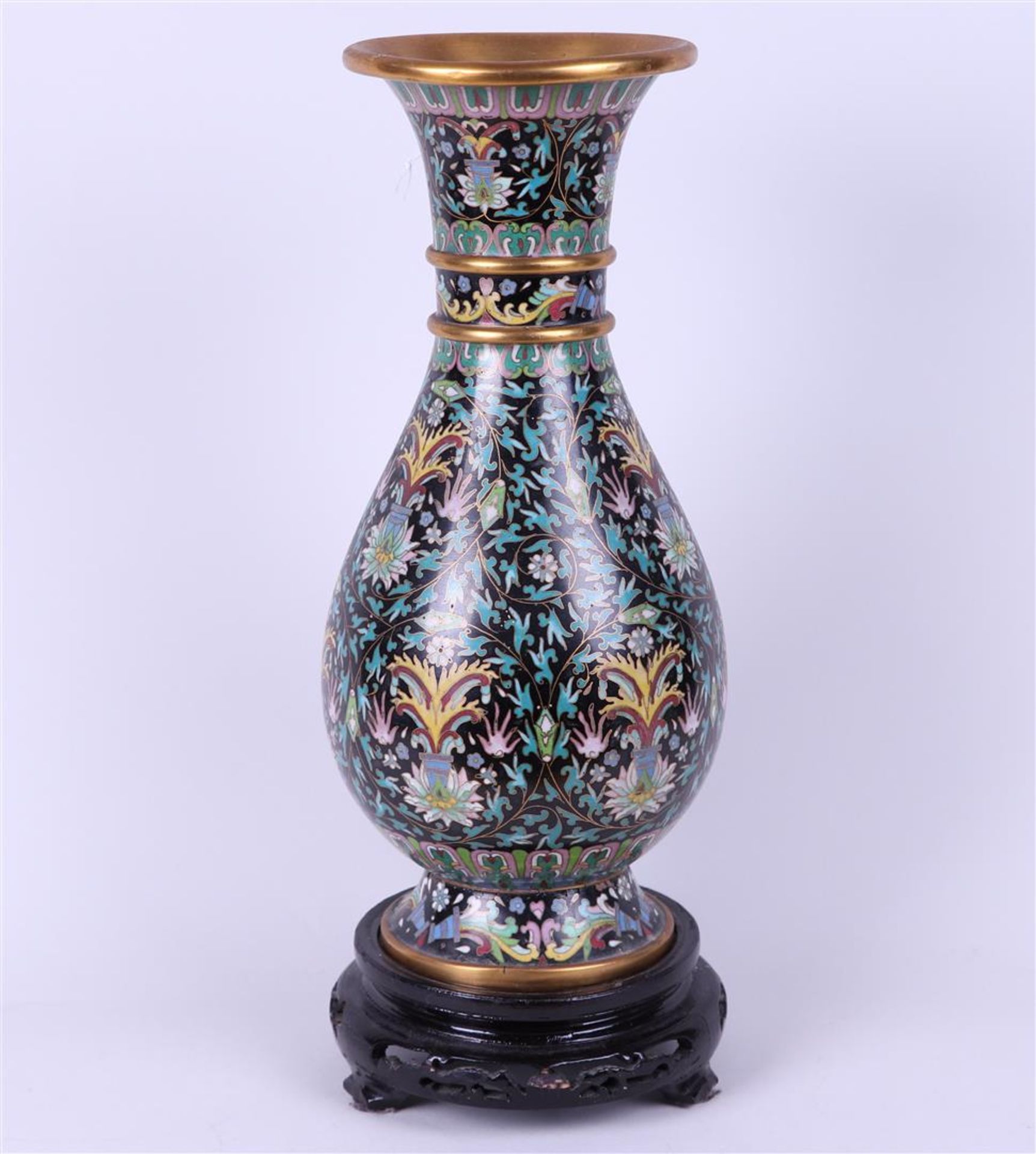 A cloisonne vase on a wooden base with floral decor. China, 20th century.
