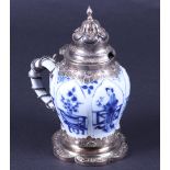 A porcelain jug with a decor of frames and flower pots in compartments, in a silver frame. China, Ka