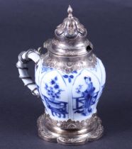 A porcelain jug with a decor of frames and flower pots in compartments, in a silver frame. China, Ka