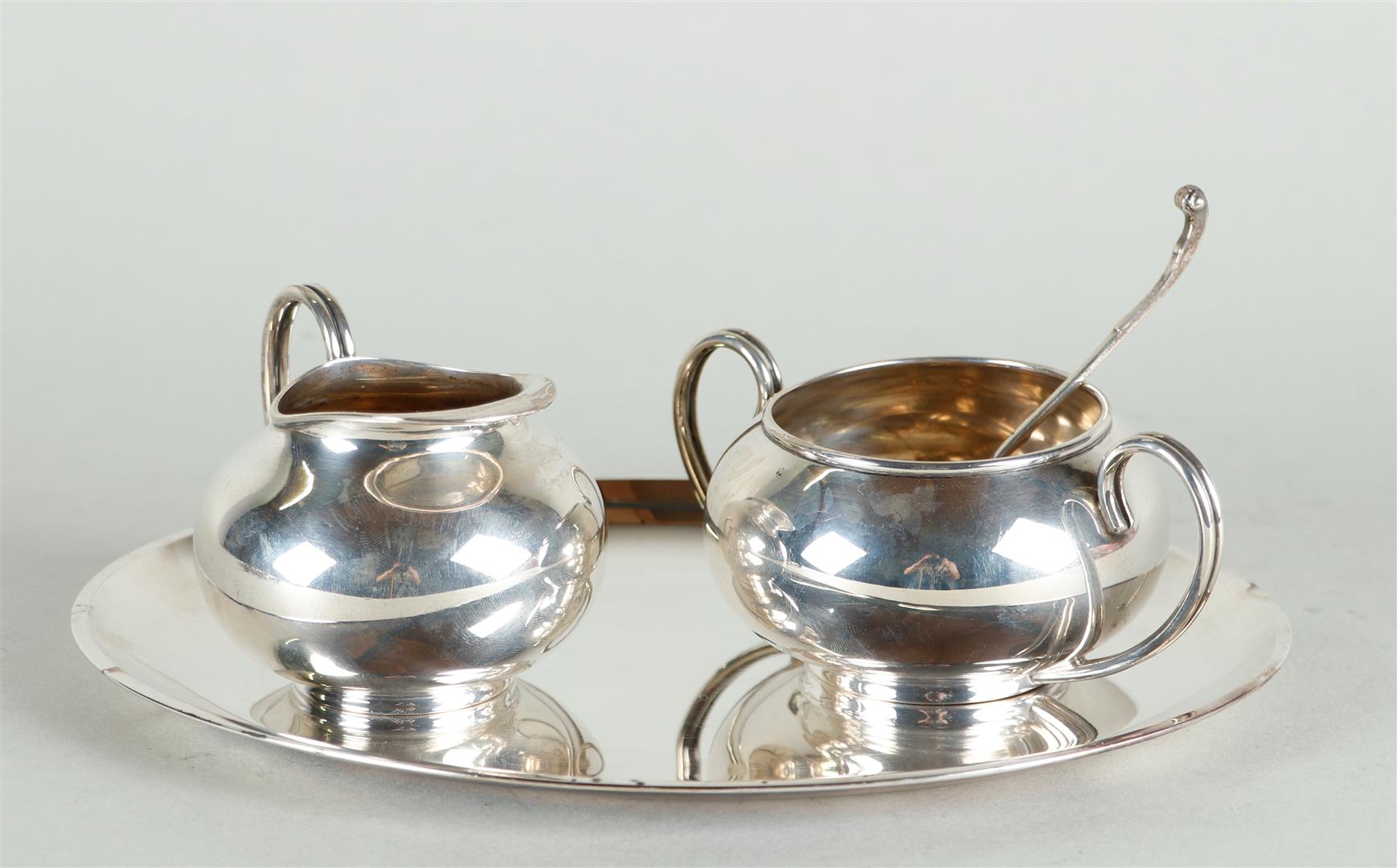 Silver cream set on tray and matching sugar spoon. Marked on the bottom with Voorschoten