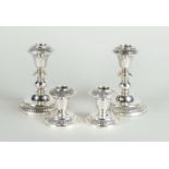 Two sets of silver candlesticks, marked 'Silver'. 