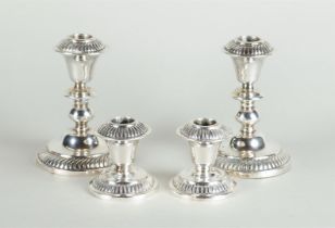 Two sets of silver candlesticks, marked 'Silver'.