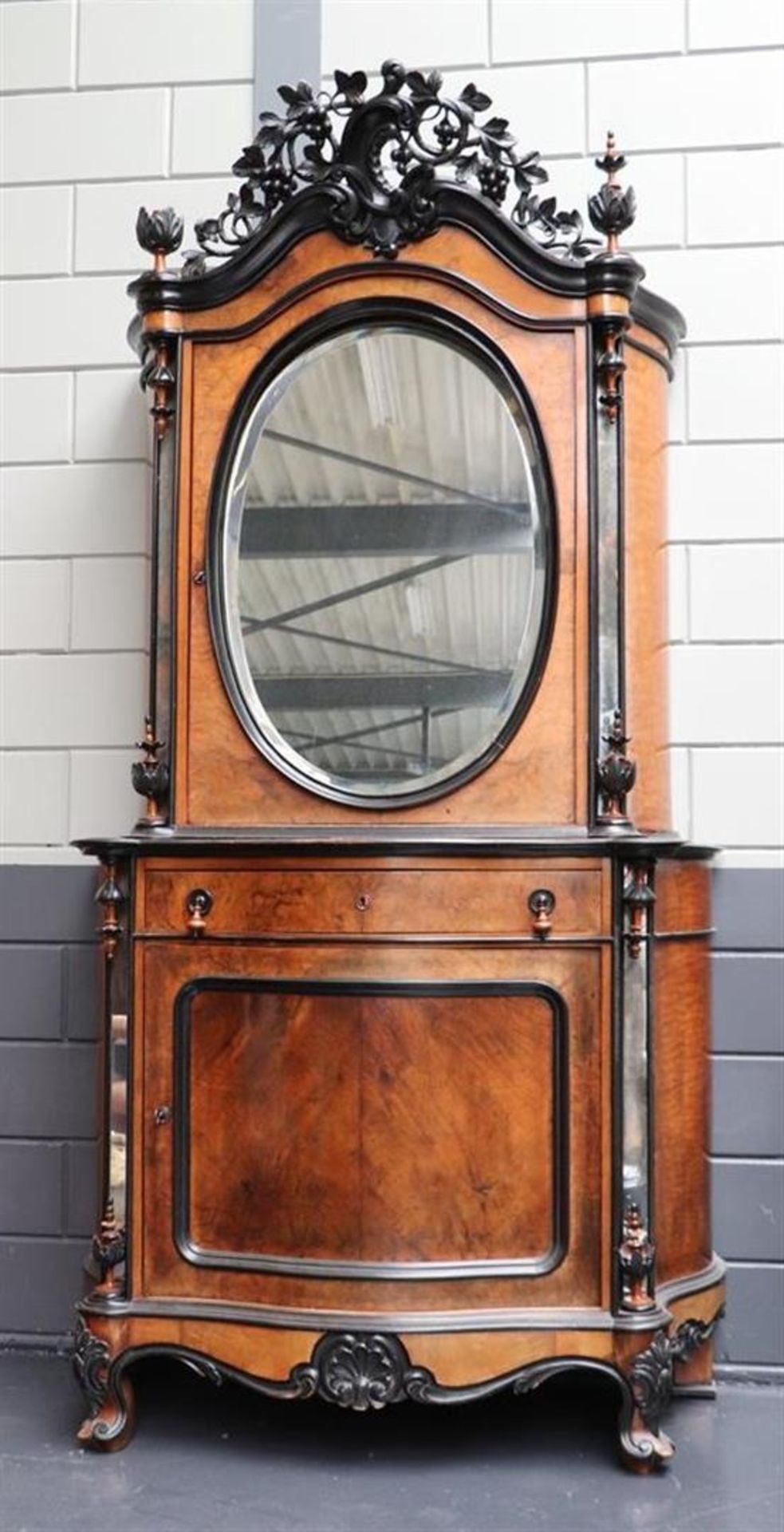 A Willem III Bonheur du Jour, with a richly carved crest, cut mirror in a single top door, a drawer 