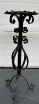 A wrought iron candle stand.