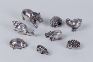 A lot consisting of (8) silver miniature animals including (6) pill boxes, a table number holder and