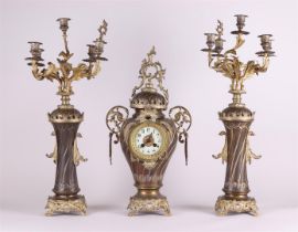 A French Garniture de Chéminé or clock set, consisting of a mantel clock and two five-armed candlest