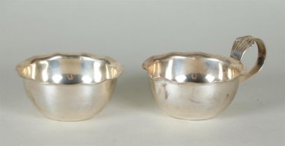 A silver cream set with a lobed edge. Gebr. Huisman, marked with a sword