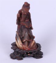 A philosopher in horn on a wooden base. China, circa 1900.
