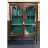 A 'Georgian' display cabinet with two shelves and supported by tapered legs. 