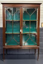 A 'Georgian' display cabinet with two shelves and supported by tapered legs. 