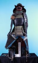 An antique Edo period, black lacquered Japanese armor (yoroi) laced with navy blue and green cords a