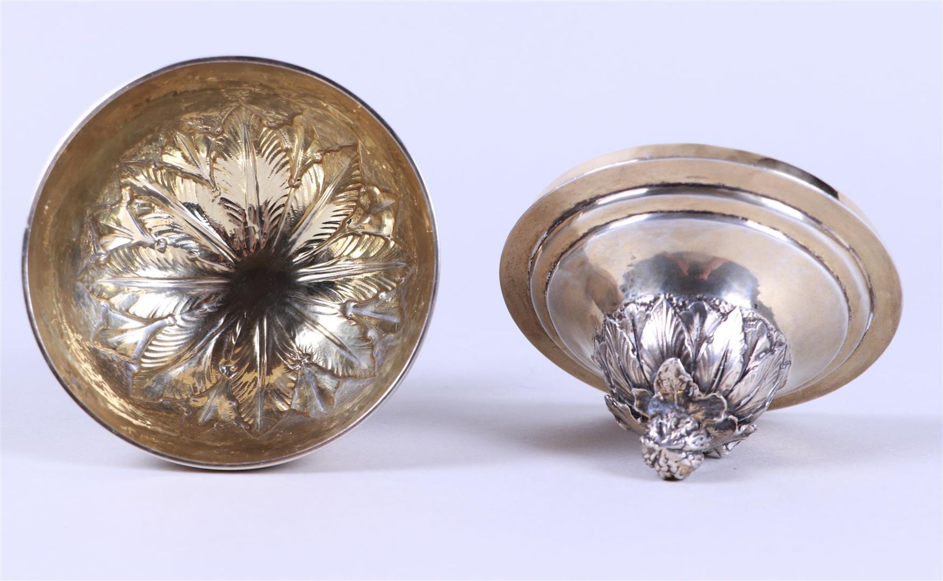 A silver lidded coupe on a round base with a constricted base surrounded by palm leaves, the lid wit - Image 3 of 3