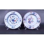 Two porcelain Famille Verte plates; one with floral decor, the other with scroll decor with a river 