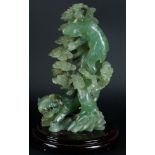 A large Jade statue with decoration of a tiger and a bear near a tree. China, 20th century.
