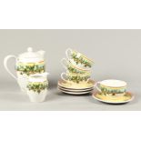 A lot of porcelain consisting of a coffee pot, cream jug and four cups and saucers with ivy leaves d