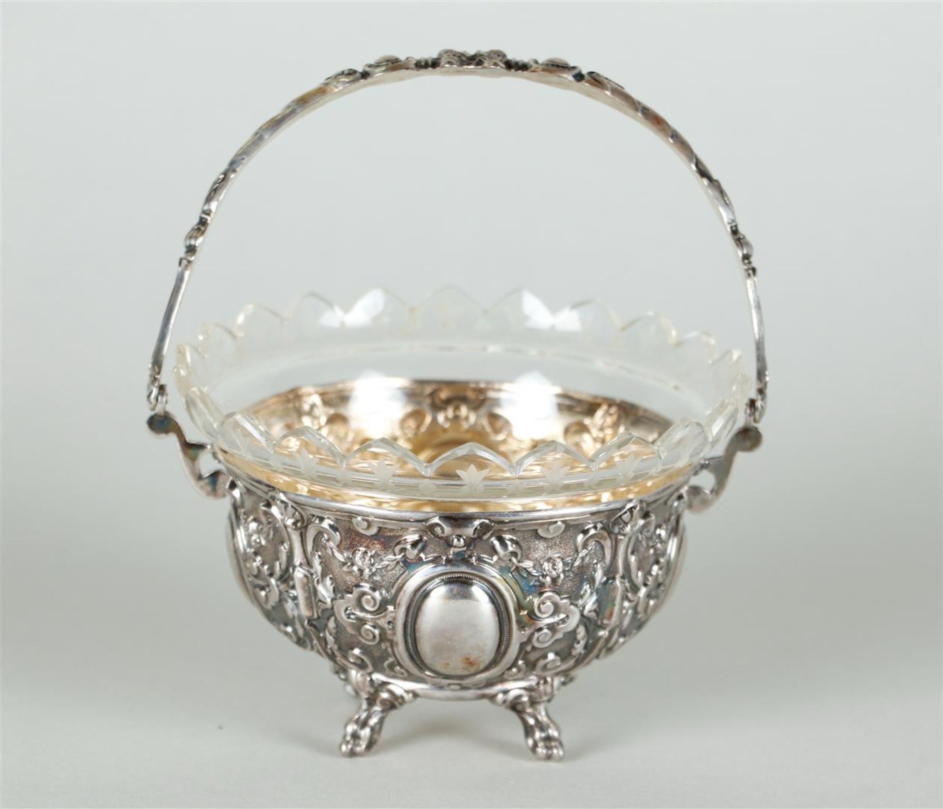 A cut glass chocolate dish in Neo Renaissance silver frame. Unclearly marked on the handle