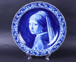 A large earthenware wall dish with an image after Vermeer 'Girl with a pearl earring'. Delft porcela