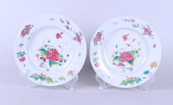 Two deep Famille Rose plates with floral decor in the outer edge, insects among the floral decoratio