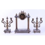 A mantel clock consisting of two candlestick holders and a mantel clock