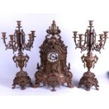 A large bronze clock set consisting of a clock and two 5-armed candlesticks. France, 19th century.
