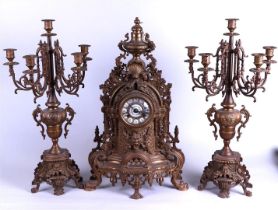 A large bronze clock set consisting of a clock and two 5-armed candlesticks. France, 19th century.