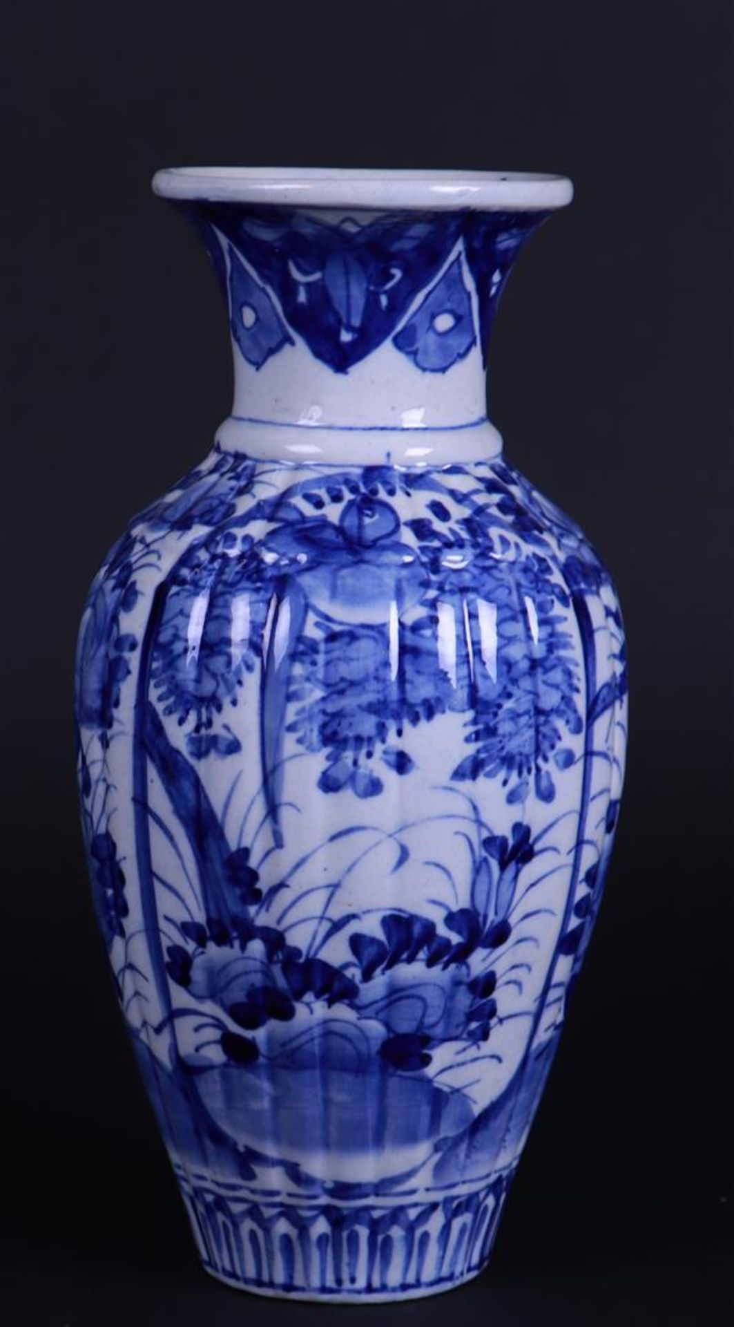 A porcelain ribbed vase with floral decor. Japanese 19th century.
