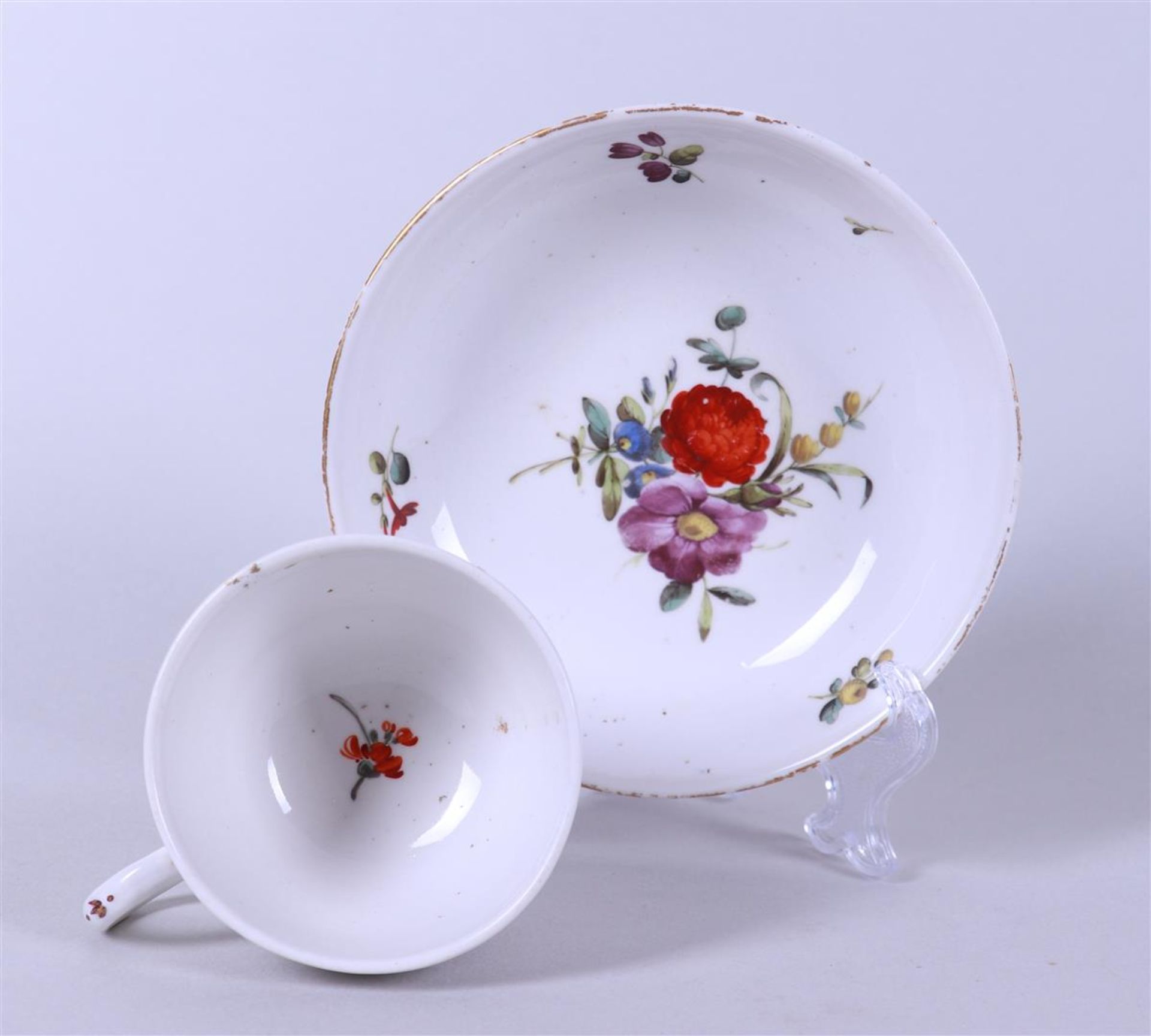 A cup and saucer with floral decor, marked on the bottom.  - Image 2 of 3