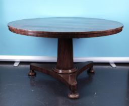 A mahogany Biedermeier column table on three legs. Holland ca 1830/50.
