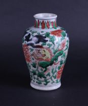 A porcelain Wucai vase decorated with dragons and flowers. China, transition.
