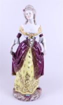 A porcelain statue of a lady in an evening dress. 