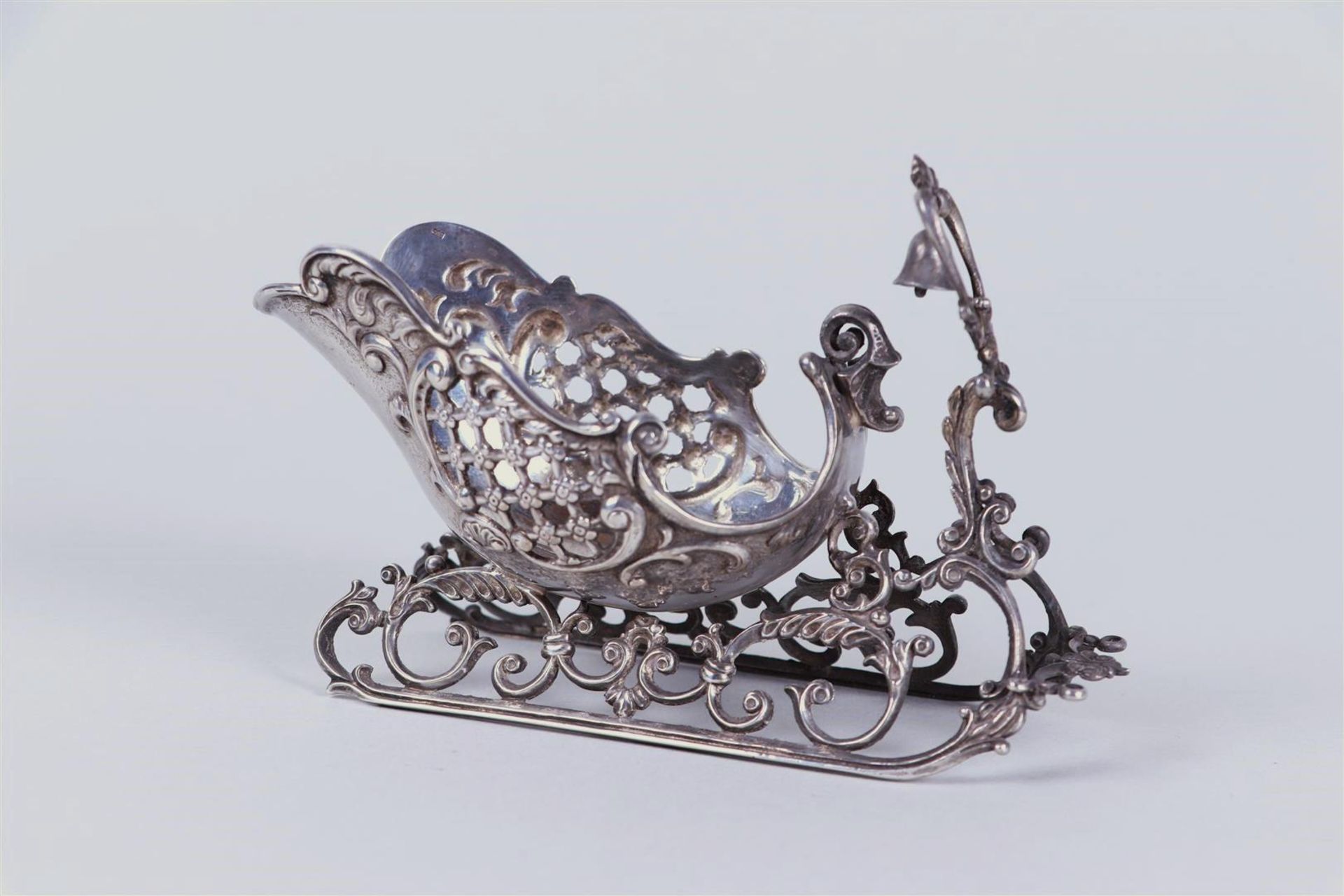 A silver scale model of a sleigh. Marked '835'. 