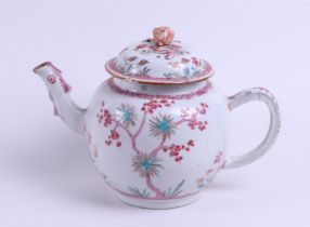 A large porcelain Famille Rose teapot with rich formal decoration, with an embossed flower bud as a