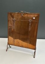 A copper fire screen