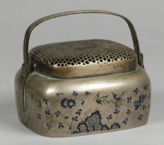 A bronze hand warmer decorated with enamel. China, late 19th century.