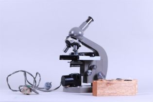 An OlympusTokyo laboratory microscope with extra lenses and lighting in original case.